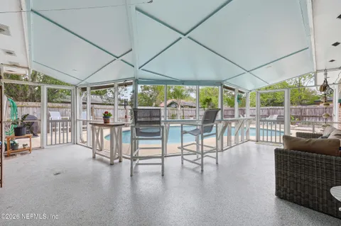 a view of a swimming pool with chairs