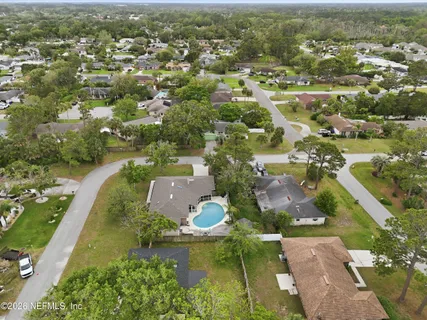 an aerial view of residential houses with outdoor space