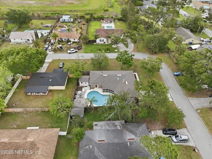 an aerial view of residential houses with outdoor space