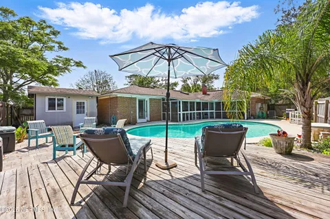 a view of a chairs and table in backyard