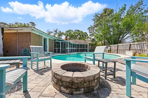 a view of backyard with a patio and a garden