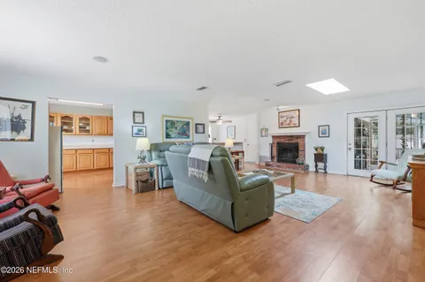 a living room with furniture a fireplace and wooden floor