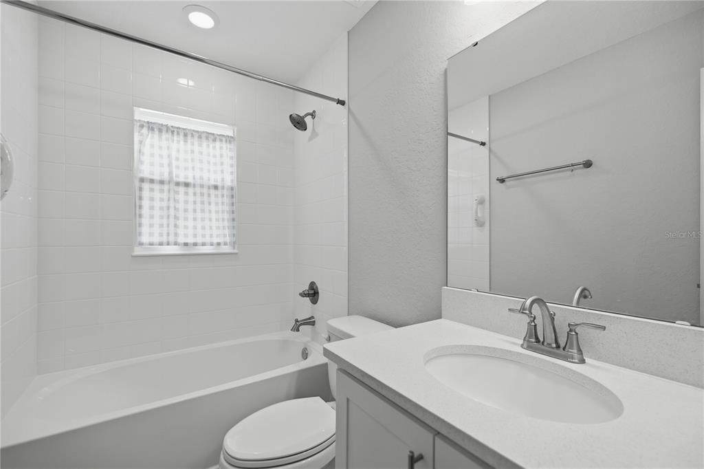 4611 Southeast 89th Street Ocala, FL 34480 - Photo 22 of 33 a bathroom with a granite countertop toilet sink and bathtub