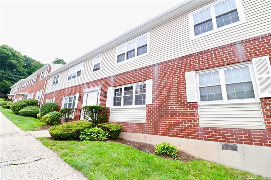 50 Greenhouse Road, Unit 18C Bridgeport, CT 06606 - Photo 1 of 1 a front view of a house with a garden