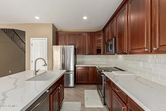a kitchen with a stove a sink and a refrigerator