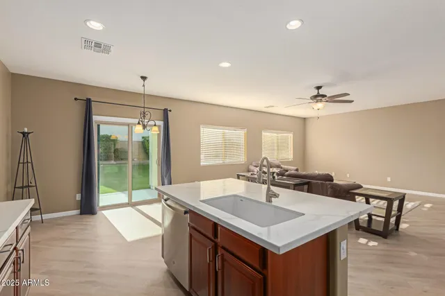 a kitchen with granite countertop a stove top oven microwave and cabinets