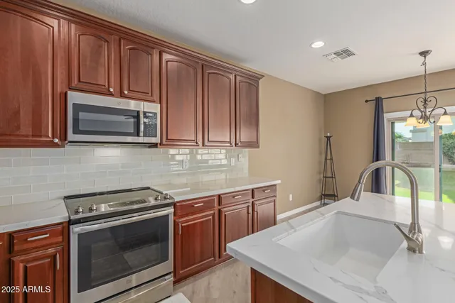 a view of a big room with wooden floor and windows