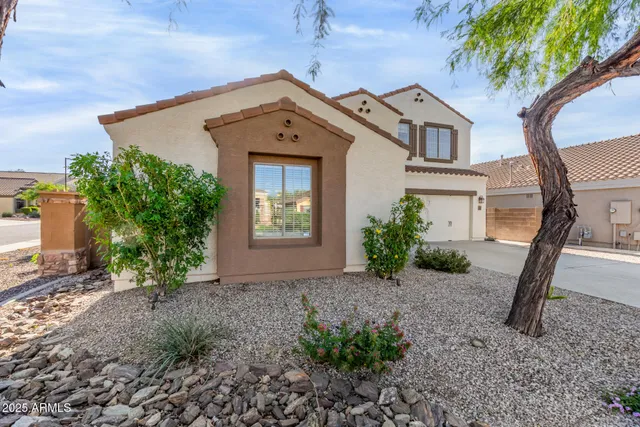 a front view of a house with garden