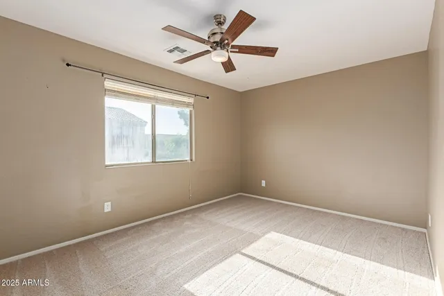 a view of a room with a ceiling fan