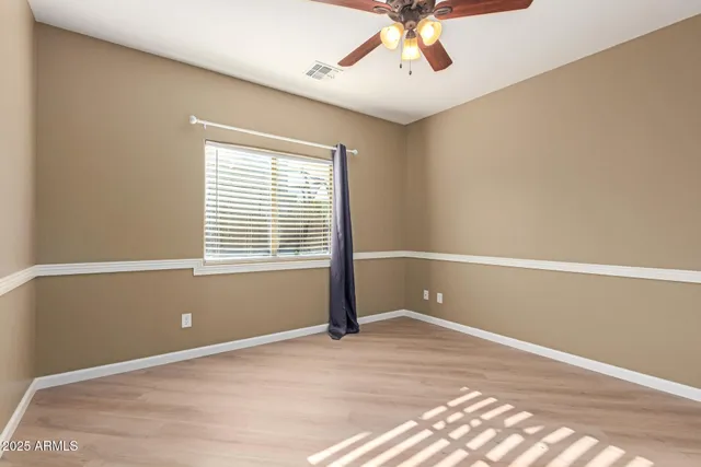 a view of a livingroom with a ceiling fan and wooden floor