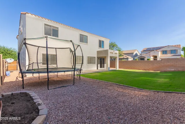 a view of a backyard with plants and a garden