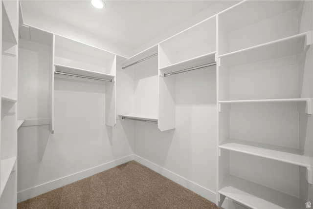 175 West 930 North Santaquin, UT 84655 - Photo 17 of 22 Walk-in closet featuring built-in white shelving, multiple hanging rods, recessed lighting, and carpet flooring