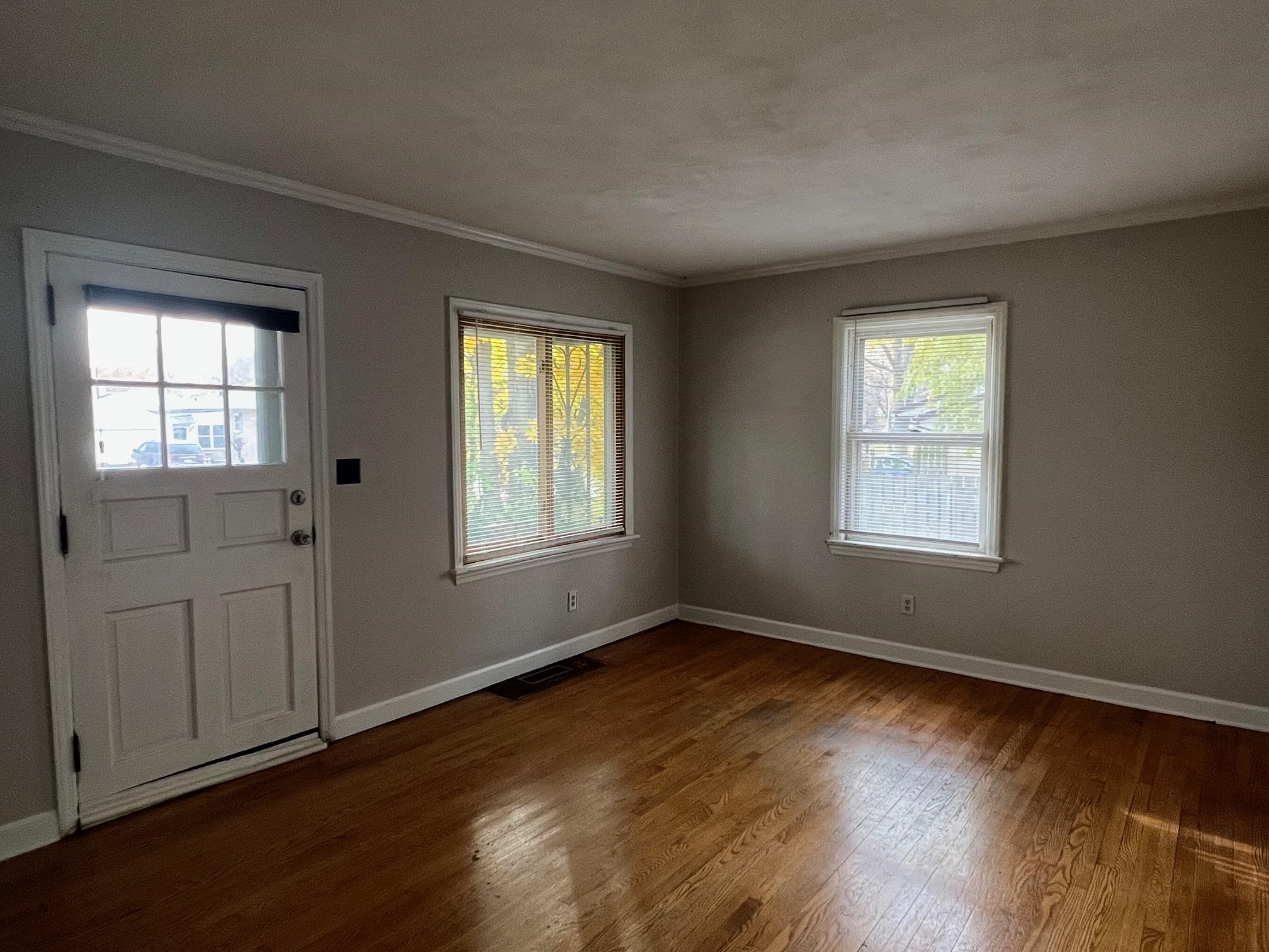 3906 Abbotsford Road Rockford, IL 61107 - Photo 2 of 16 a view of an empty room with wooden floor and a window