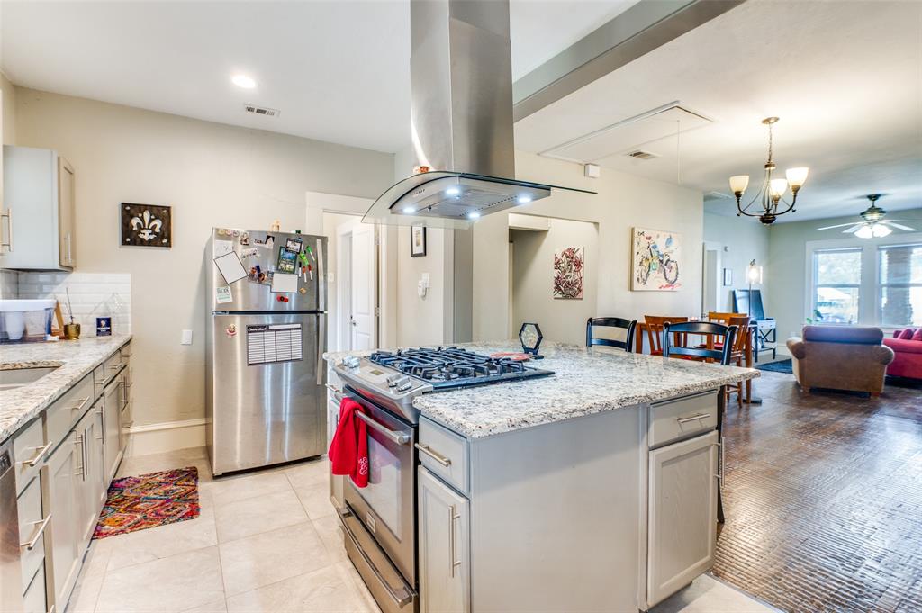a kitchen with stainless steel appliances granite countertop a stove refrigerator and cabinets