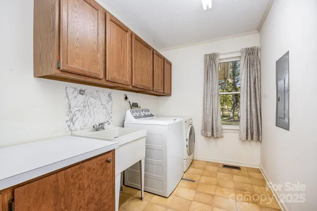 a utility room with cabinets washer and dryer