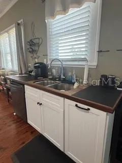 a kitchen with a sink cabinets and window