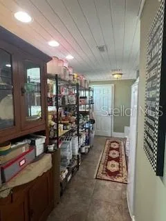 a view of a room with lots of wooden furniture