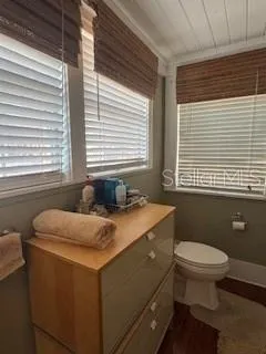 a bathroom with a sink a toilet and a window