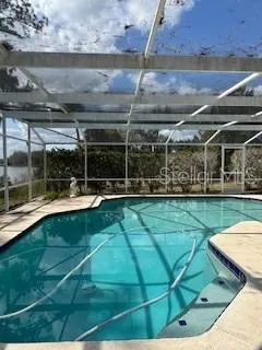a view of a swimming pool with a patio