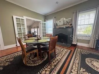 a view of a dining room with furniture window and wooden floor