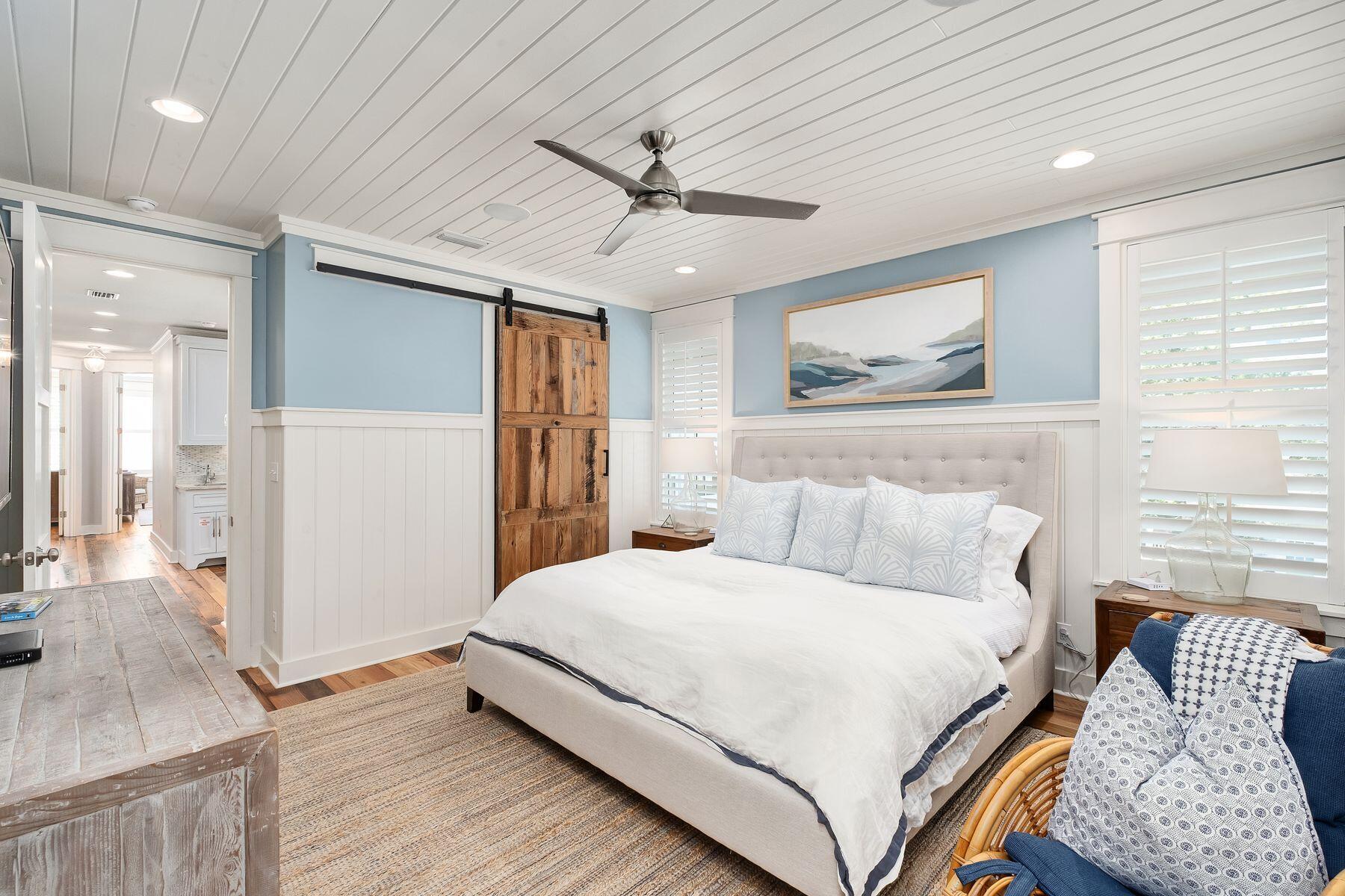 13 Madaket Way Watersound, FL 32461 - Photo 23 of 51 a bedroom with a large bed and a chandelier