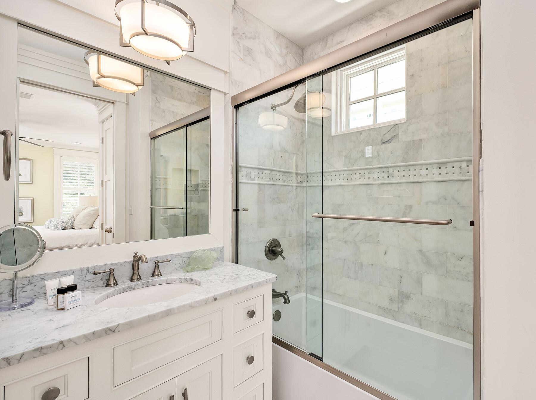 13 Madaket Way Watersound, FL 32461 - Photo 28 of 51 a bathroom with a granite countertop sink a mirror and a shower