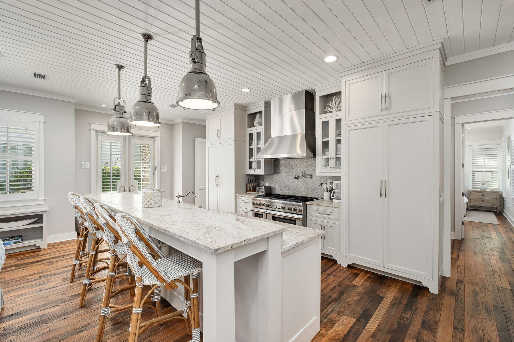 13 Madaket Way Watersound, FL 32461 - Photo 9 of 51 a kitchen with stainless steel appliances a stove a refrigerator a kitchen island a sink cabinets and wooden floor