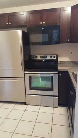 a stove top oven sitting inside of a kitchen