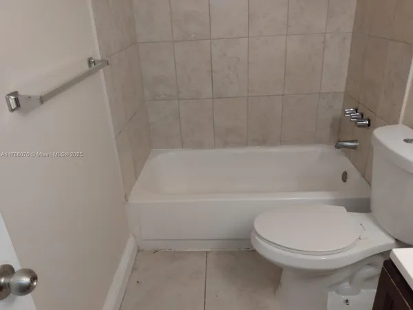 a white toilet sitting next to a bath tub