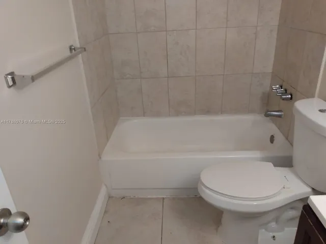 a white toilet sitting next to a bath tub