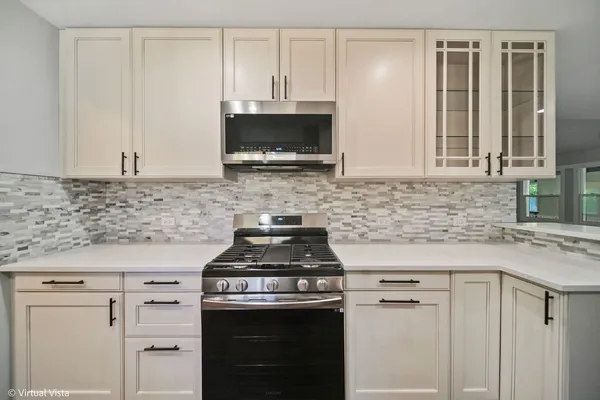 a kitchen with cabinets appliances and a sink