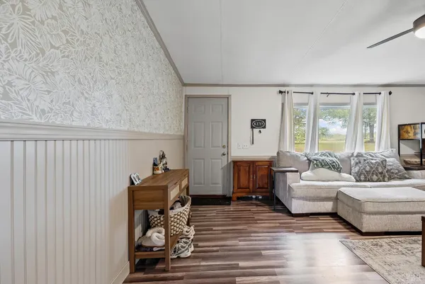 a living room with furniture and a large window