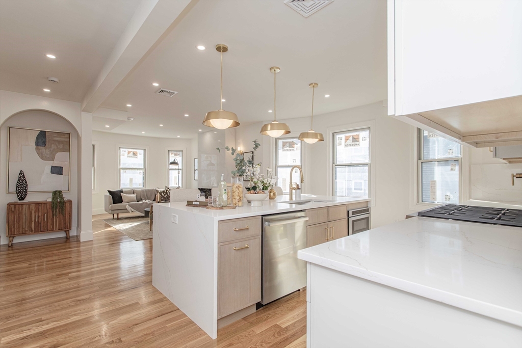 125 Mt Vernon Street, Unit 2 Newton, MA 02465 - Photo 9 of 36 a kitchen with lots of counter top space and living room