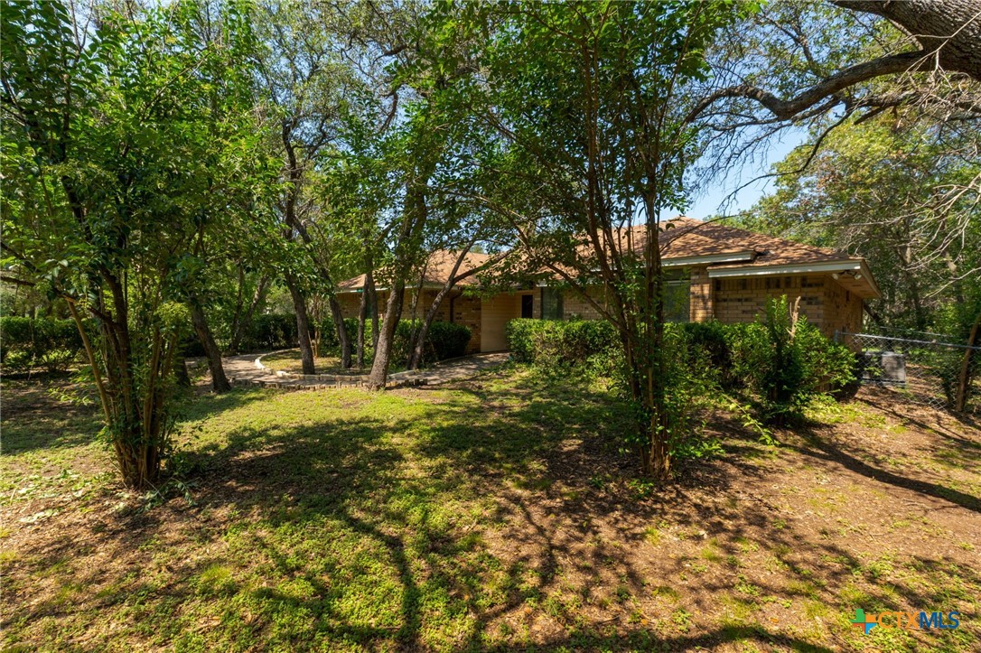 a view of a house with backyard and sitting area