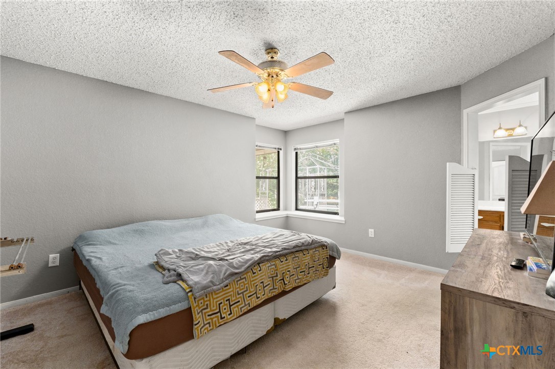2187 Stagecoach Road Killeen, TX 76542 - Photo 11 of 27 a bedroom with a bed and a chandelier