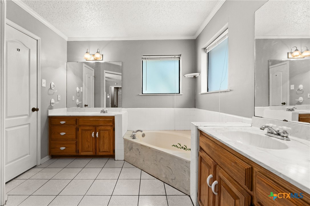 2187 Stagecoach Road Killeen, TX 76542 - Photo 14 of 27 a spacious bathroom with a granite countertop sink mirror and bathtub