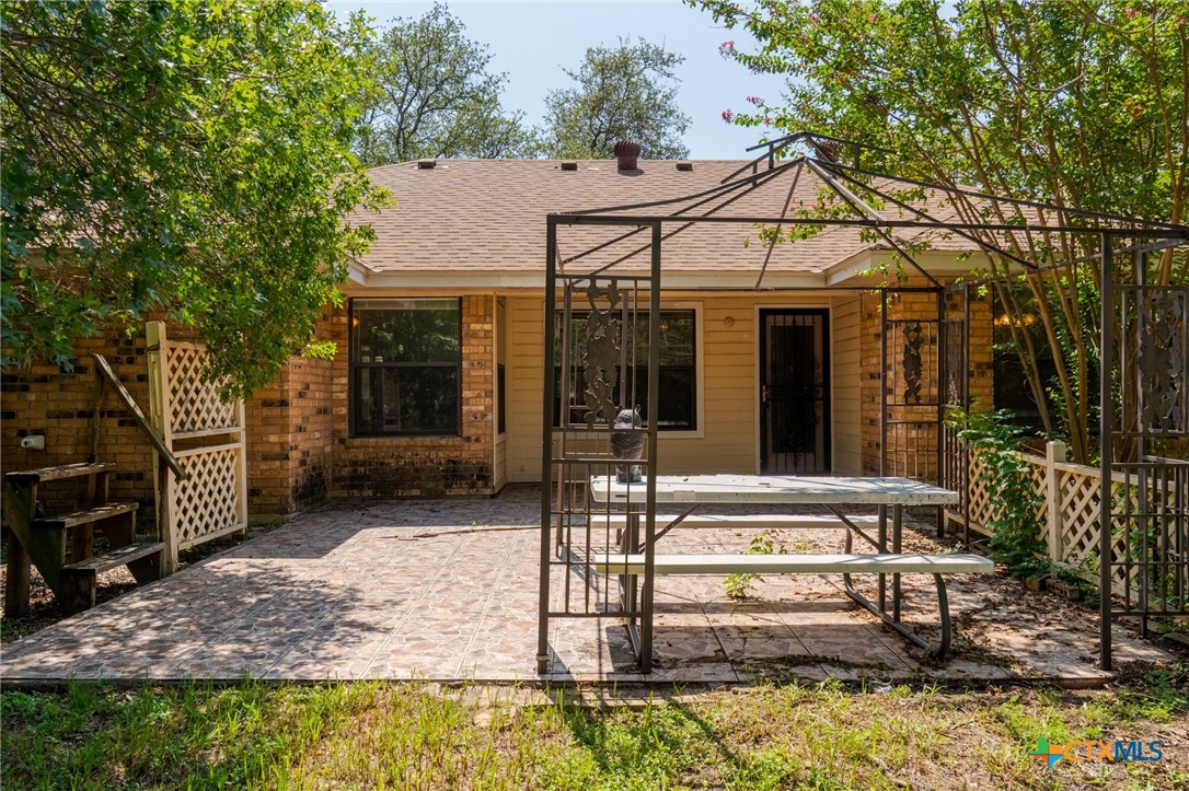 2187 Stagecoach Road Killeen, TX 76542 - Photo 20 of 27 a view of a white house with large windows and a table and chairs