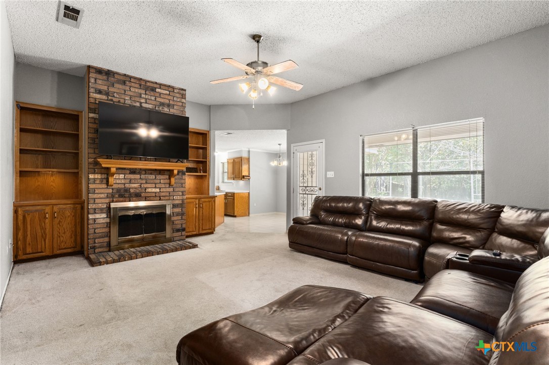 2187 Stagecoach Road Killeen, TX 76542 - Photo 5 of 27 a living room with furniture a fireplace and a flat screen tv