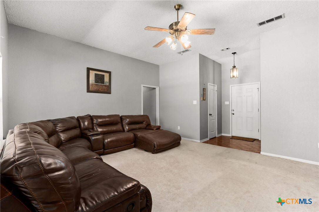 2187 Stagecoach Road Killeen, TX 76542 - Photo 7 of 27 a living room with furniture and a chandelier