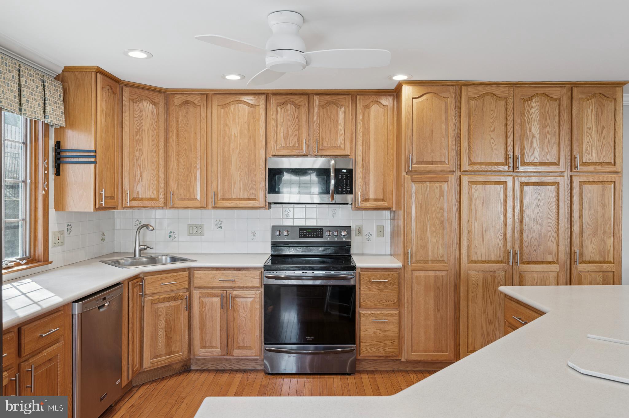 946 Georgetown Road Swarthmore, PA 19081 - Photo 14 of 36 a kitchen with stainless steel appliances granite countertop a stove a sink and a microwave