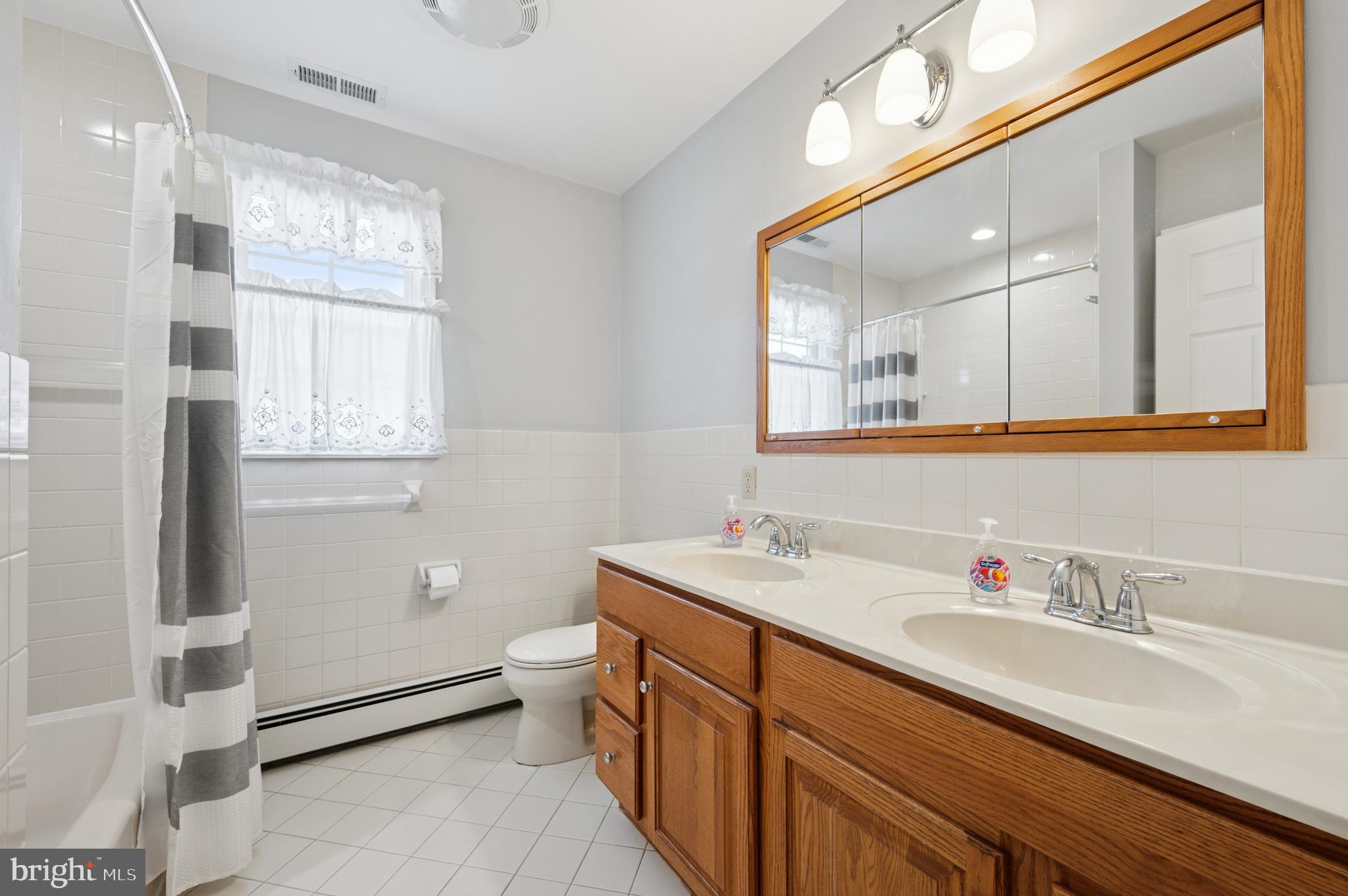 946 Georgetown Road Swarthmore, PA 19081 - Photo 27 of 36 a bathroom with a sink double vanity and a mirror