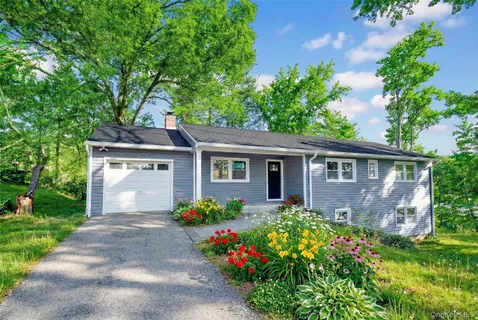 a front view of house with yard and green space