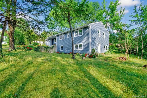 a front view of house with yard and trees
