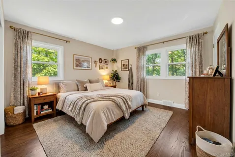 a bedroom with a bed and a large window