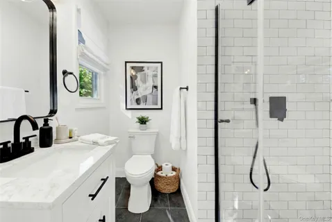 a bathroom with a sink mirror vanity and toilet