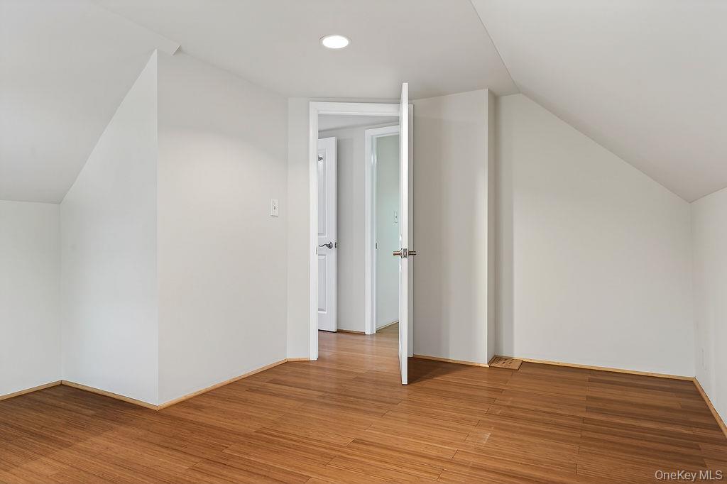 6 Winterberry Road Fishkill, NY 12524 - Photo 28 of 43 Spacious room featuring wood-finish flooring, white walls, and recessed ceiling lighting.