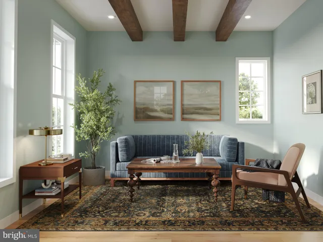 a living room with furniture and a potted plant