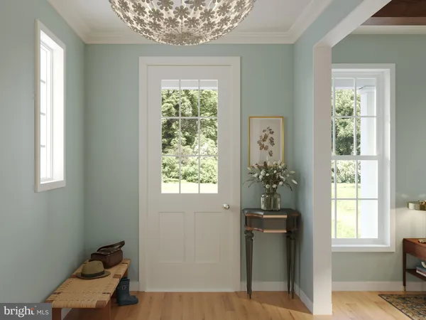 a view of a hallway with windows and chandelier