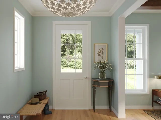 a view of a hallway with windows and chandelier