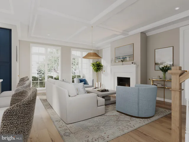 a living room with furniture a large window and a fireplace